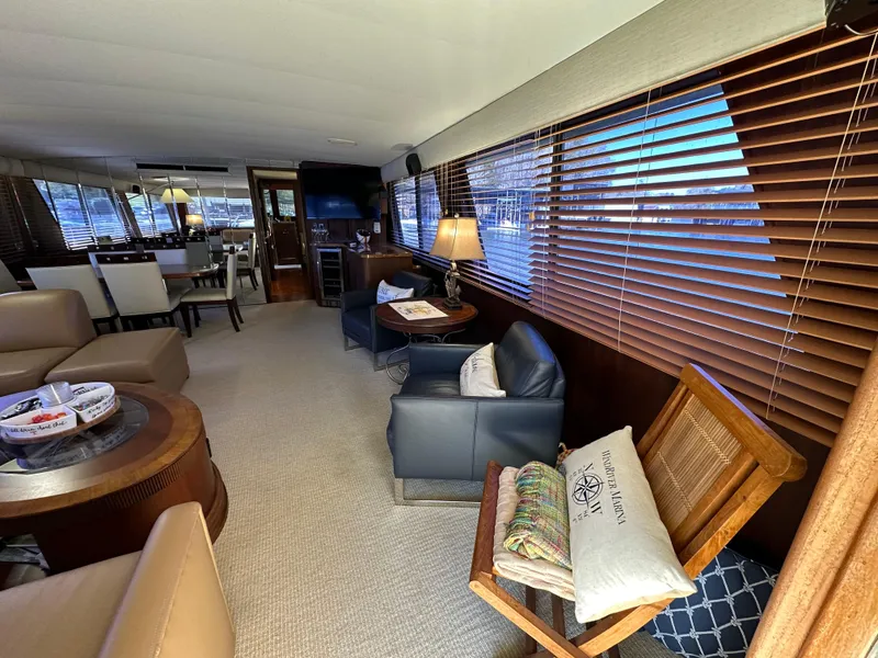 Slide: The Image of Interior of 1987 Hatteras 63 Motor Yacht with elegant seating and wooden blinds. - 18