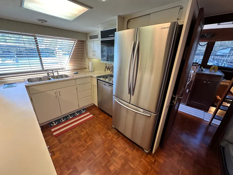 Slide: The Image of Kitchen area of a 1987 Hatteras 63 Motor Yacht with stainless steel appliances. - 25
