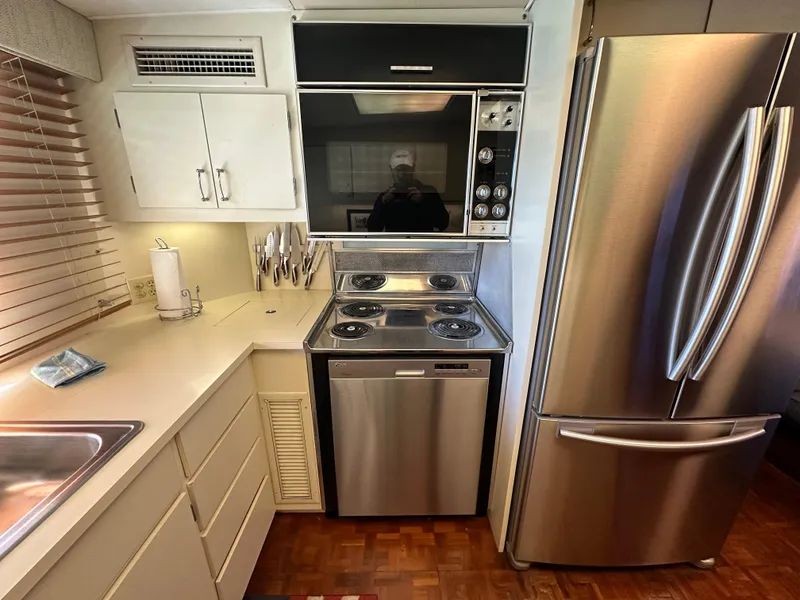 Slide: The Image of 1987 Hatteras 63 Motor Yacht kitchen with stainless steel appliances and modern cabinetry. - 26