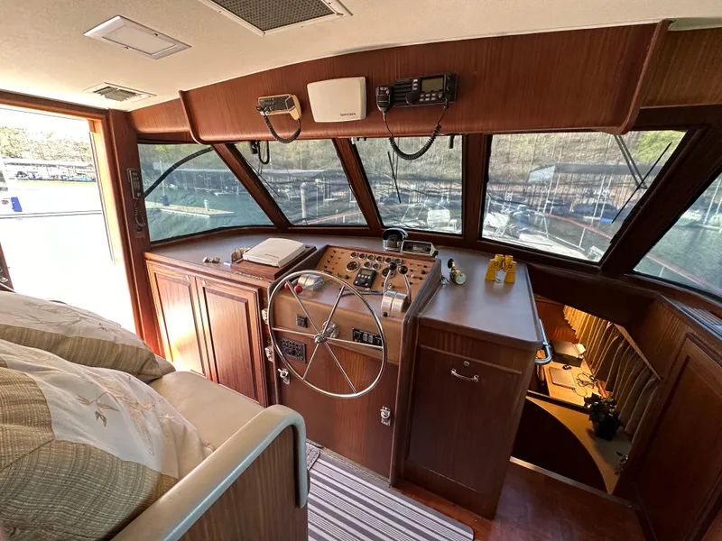 Slide: The Image of 1987 Hatteras 63 Motor Yacht helm with wooden interior and steering wheel. - 29