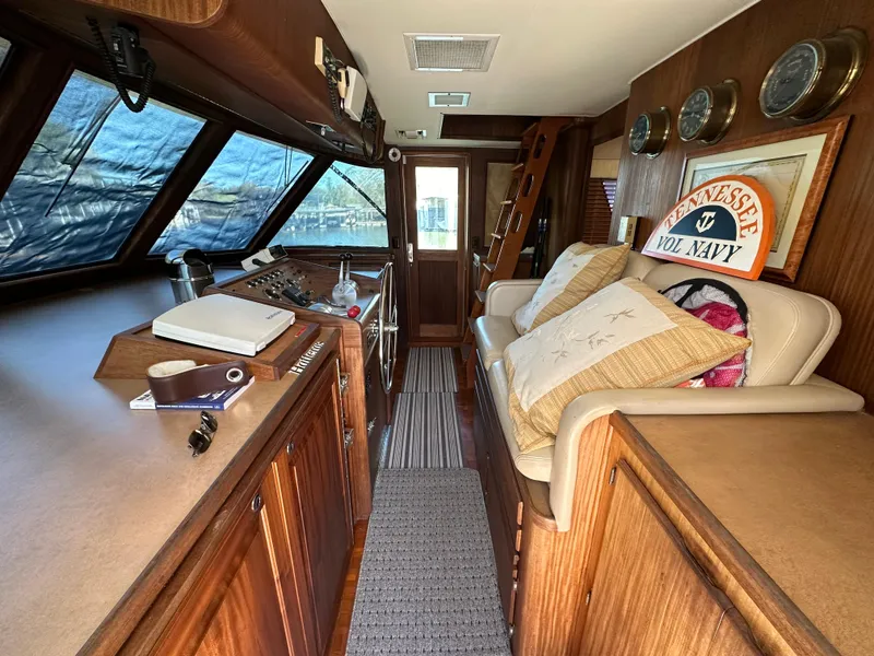 Slide: The Image of 1987 Hatteras 63 Motor Yacht interior with wood paneling and nautical decor. - 30