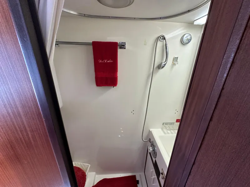 Slide: The Image of Bathroom interior of 1987 Hatteras 63 Motor Yacht with red towels and shower. - 42