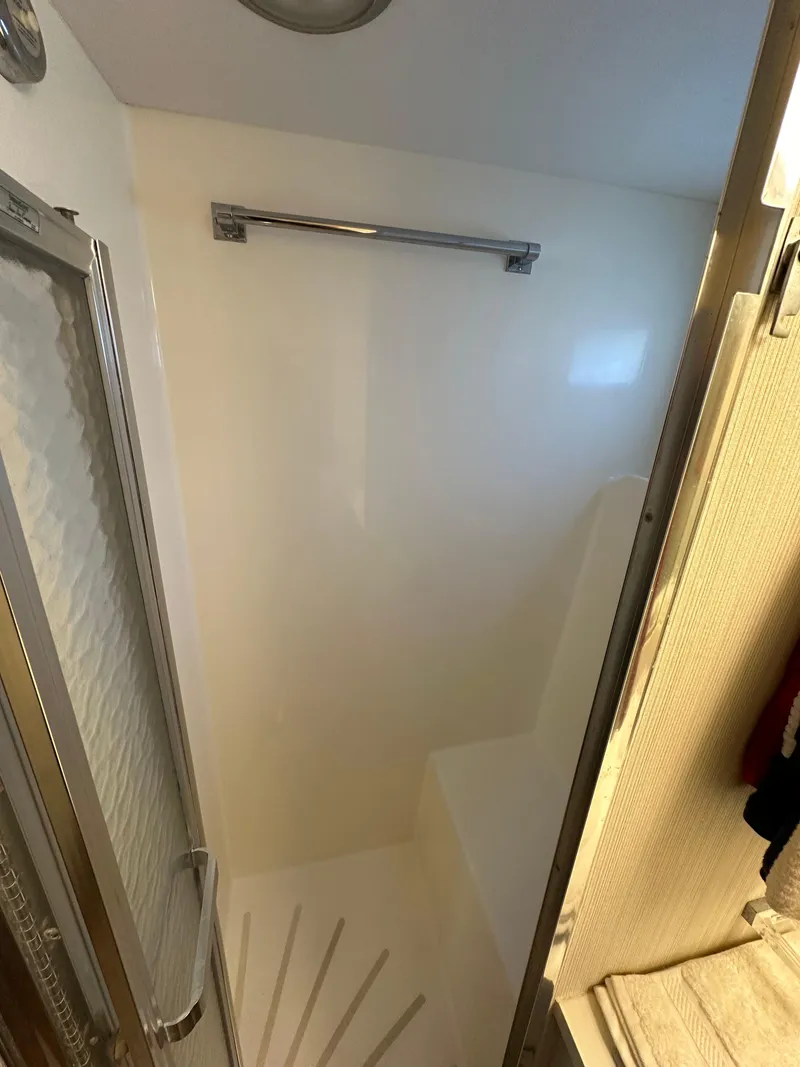 Slide: The Image of Shower area in 1987 Hatteras 63 Motor Yacht, featuring a sleek, minimalist design. - 45