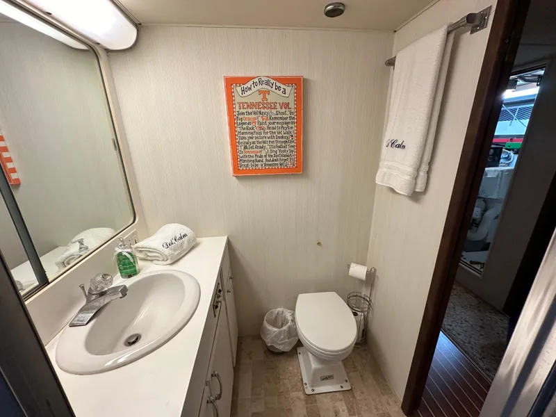 Slide: The Image of Bathroom interior of 1987 Hatteras 63 Motor Yacht with sink, toilet, and wall decor. - 46