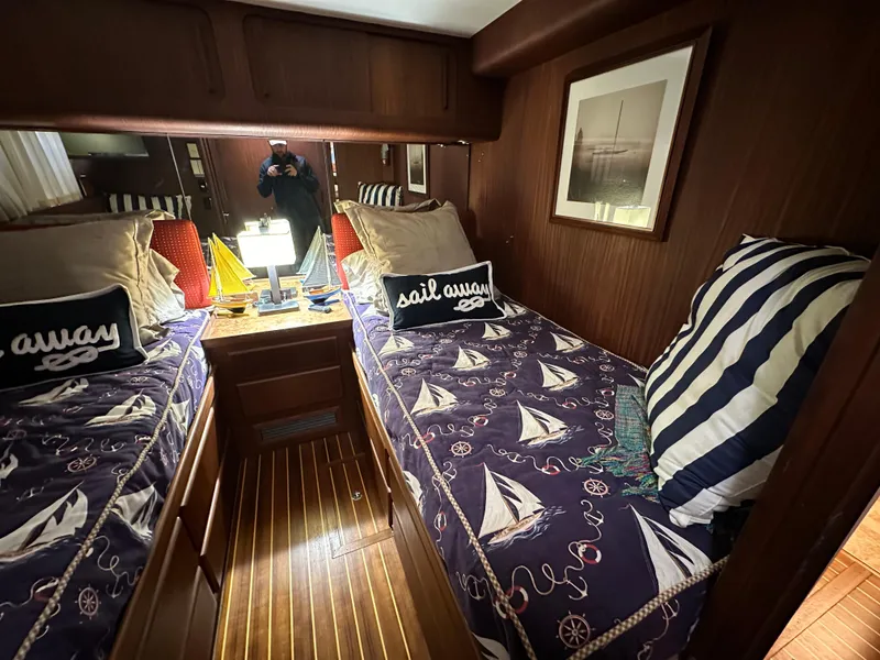 Slide: The Image of Cozy cabin interior of 1987 Hatteras 63 Motor Yacht with nautical-themed bedding. - 48
