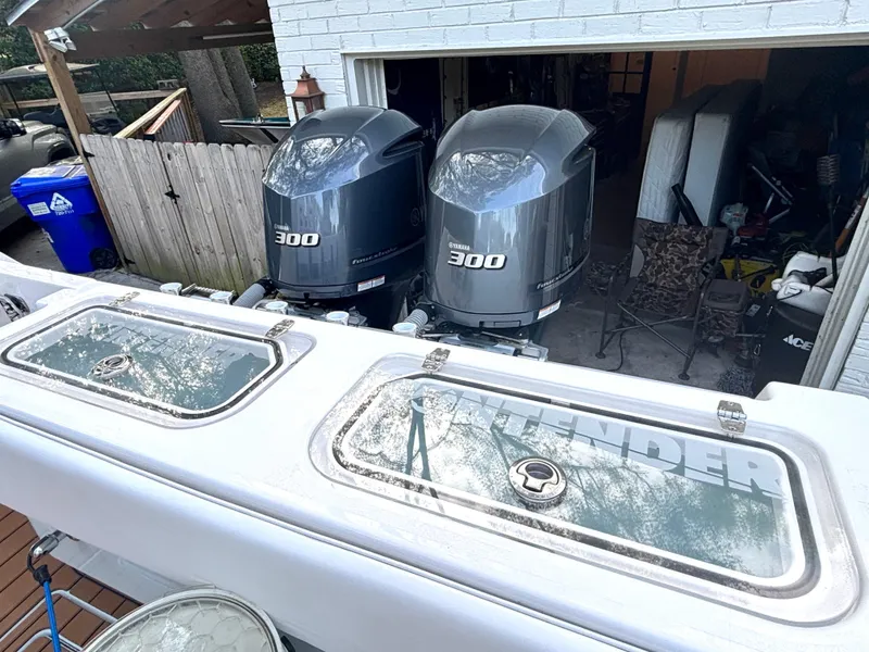 Slide: The Image of 2015 Contender 30 ST boat with twin Yamaha 300 engines in a garage setting. - 17