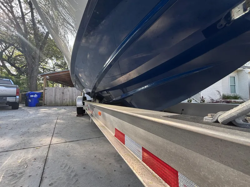 Slide: The Image of 2015 Contender 30 ST boat on trailer, parked in driveway. - 20