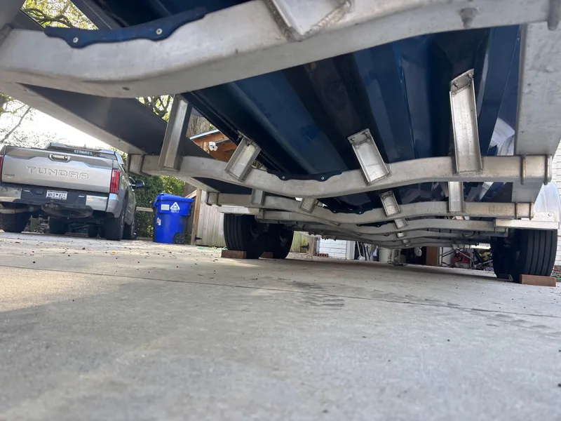 Slide: The Image of Underside view of a 2015 Contender 30 ST boat on a trailer. - 21