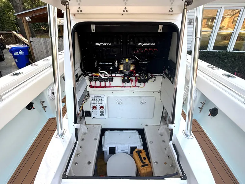 Slide: The Image of 2015 Contender 30 ST boat electronics compartment with Raymarine equipment and storage space. - 25