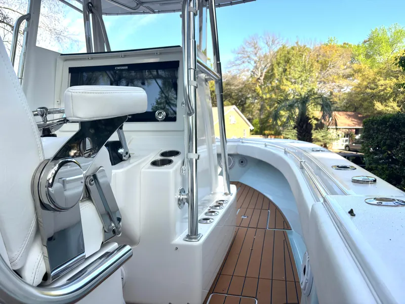 Slide: The Image of 2015 Contender 30 ST boat interior with helm and seating, featuring sleek design and wood accents. - 5