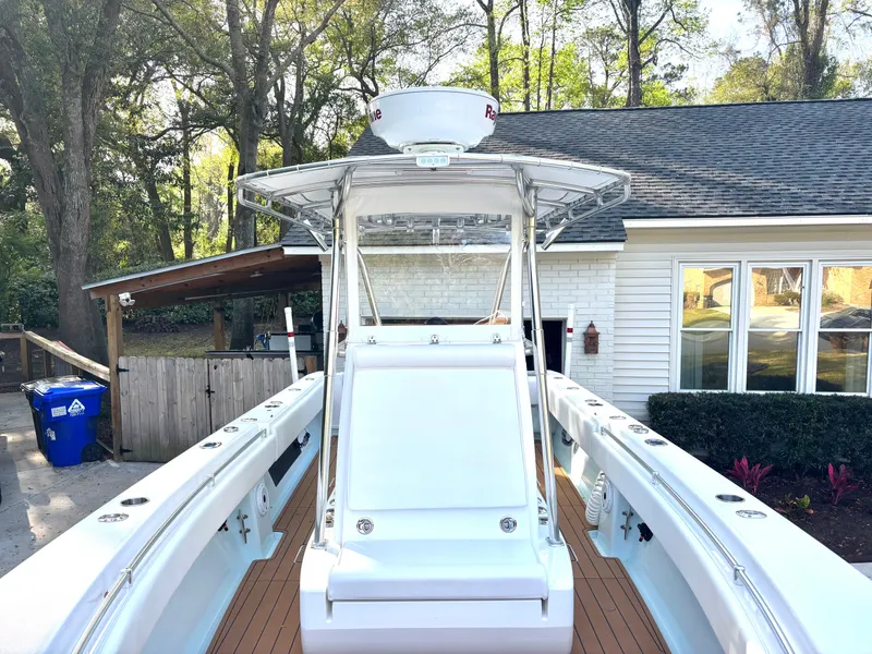Slide: The Image of 2015 Contender 30 ST boat with T-top, parked in a residential driveway. - 7