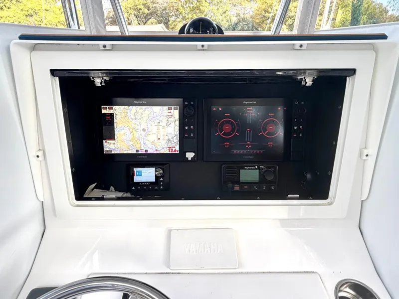 Slide: The Image of Control panel of a 2015 Contender 30 ST boat with navigation screens. - 9
