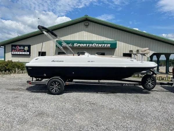 Slide: The Image of 2022 Hurricane SS 201 OB boat on trailer outside sports center. - 1
