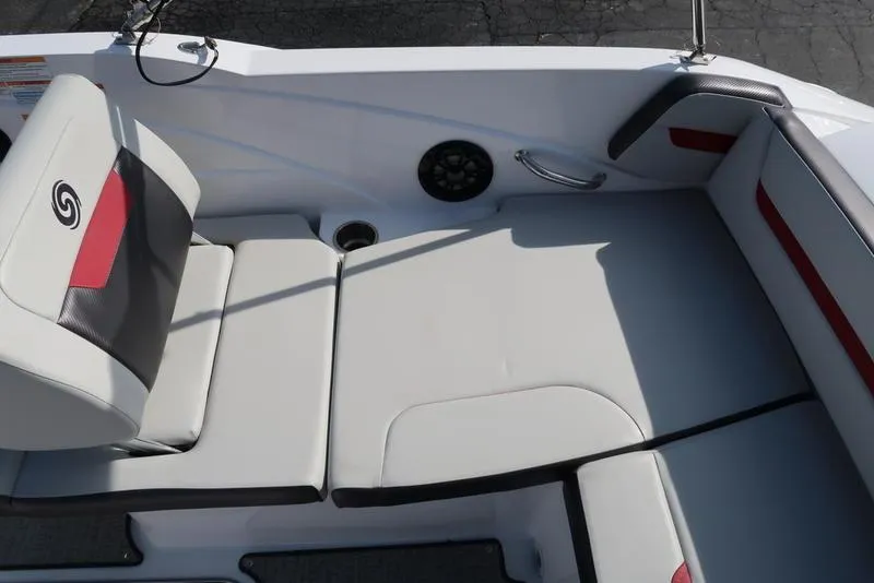 Slide: The Image of 2023 Hurricane SunDeck Sport 205 IO boat interior with cushioned seating and speaker. - 13