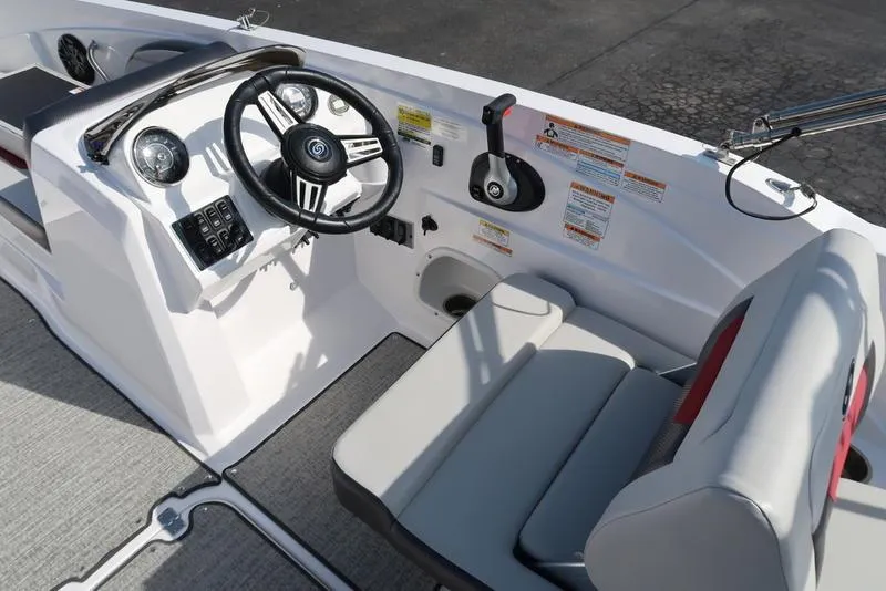 Slide: The Image of 2023 Hurricane SunDeck Sport 205 IO boat interior with steering wheel and seating. - 15