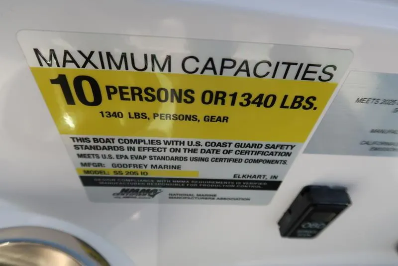 Slide: The Image of 2023 Hurricane SunDeck Sport 205 IO capacity label: 10 persons or 1340 lbs, U.S. Coast Guard compliant. - 17
