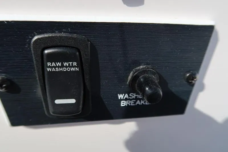 Slide: The Image of 2023 Hurricane SunDeck Sport 205 IO boat control panel with raw water washdown switch. - 20