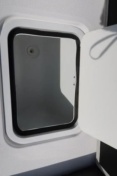 Slide: The Image of Open storage compartment on 2023 Hurricane SunDeck Sport 205 IO boat. - 28