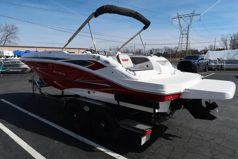 Slide: The Image of 2023 Hurricane SunDeck Sport 205 IO boat on trailer, parked outdoors. - 7