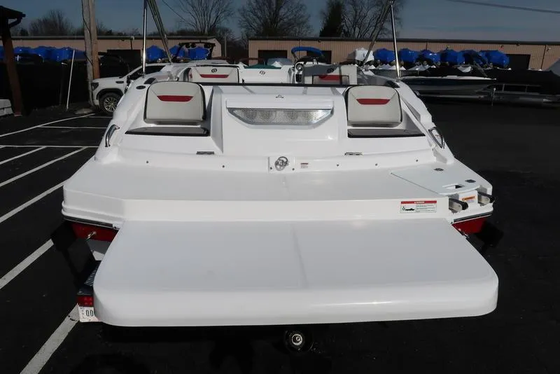 Slide: The Image of 2023 Hurricane SunDeck Sport 205 IO boat, rear view, in a parking lot. - 8