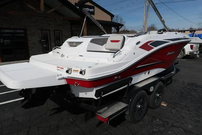 Slide: The Image of 2023 Hurricane SunDeck Sport 205 IO boat on trailer, featuring sleek red and white design. - 9