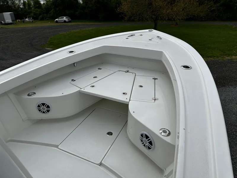 Slide: The Image of 2025 Pair Customs 24OS boat interior with storage compartments and speakers. - 12