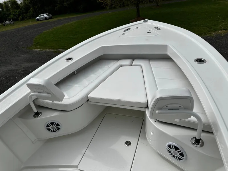 Slide: The Image of 2025 Pair Customs 24OS boat interior with white seating and speakers. - 13