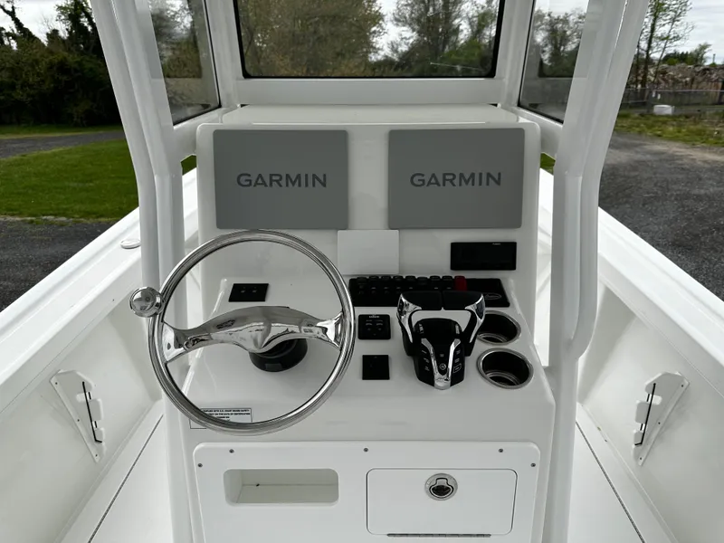 Slide: The Image of 2025 Pair Customs 24OS boat console with dual Garmin displays and steering wheel. - 14