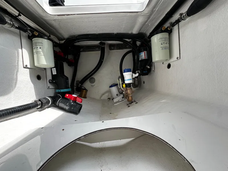 Slide: The Image of 2025 Pair Customs 24OS boat interior showing engine compartment and components. - 18