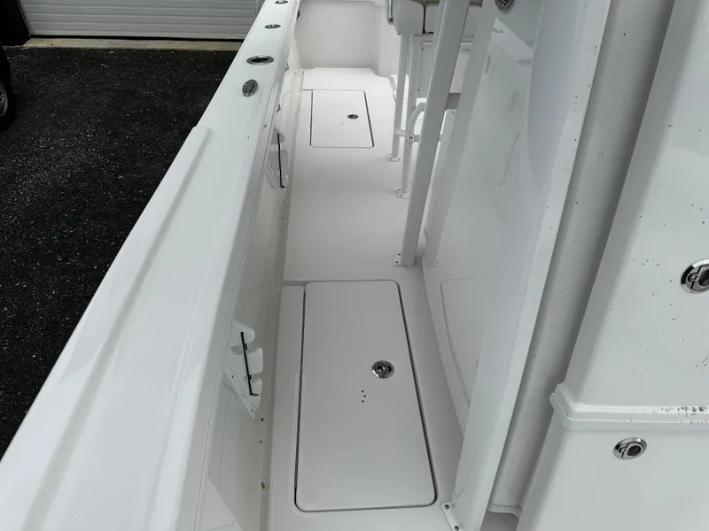 Slide: The Image of 2025 Pair Customs 24OS boat interior with sleek white deck design. - 20