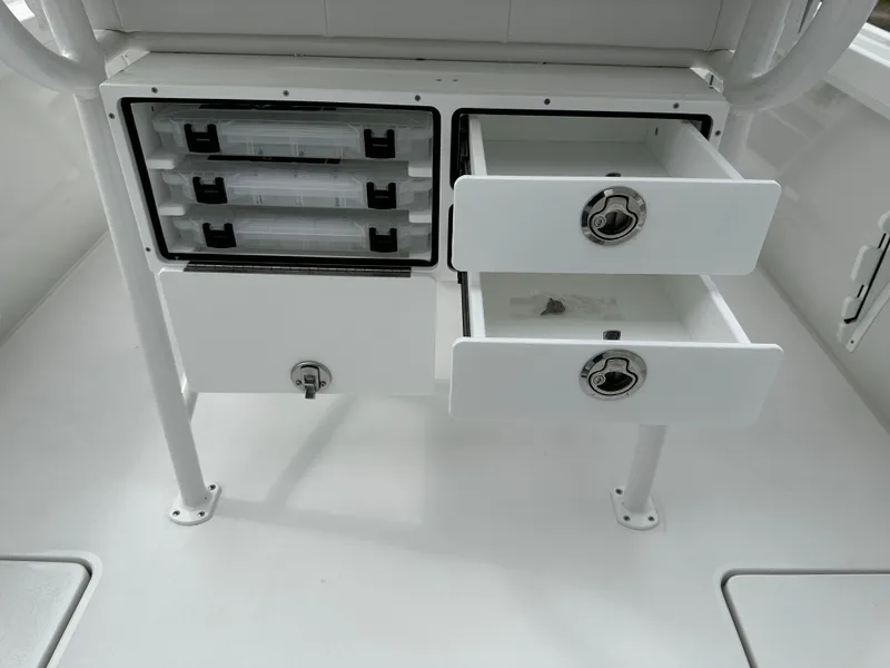 Slide: The Image of Storage drawers and compartments in a 2025 Pair Customs 24OS boat. - 8