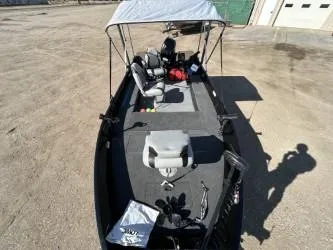 Slide: The Image of 2014 Lowe FM 160 T boat with canopy, parked on concrete surface. - 3