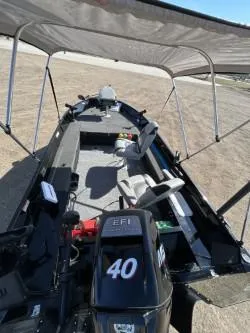 Slide: The Image of 2014 Lowe FM 160 T boat with canopy and 40 HP EFI motor on a sunny day. - 4