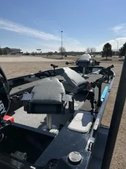 Slide: The Image of 2014 Lowe FM 160 T fishing boat with seating and motor, parked outdoors under clear sky. - 5