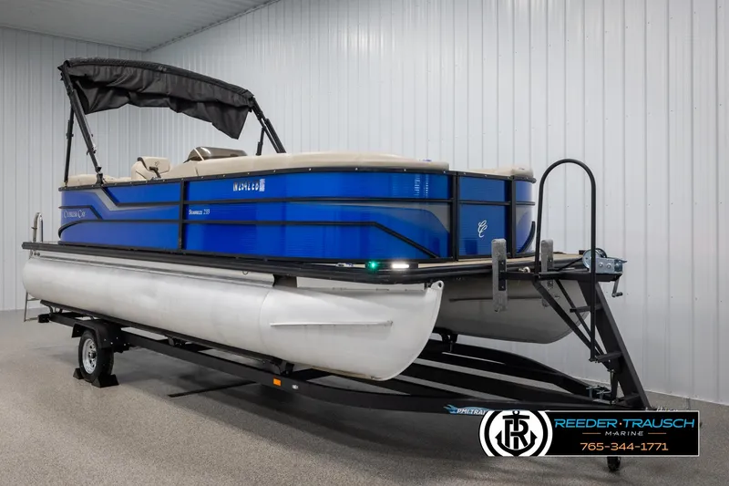 Slide: The Image of 2018 Cypress Cay 233 Seabreeze pontoon boat on trailer in indoor showroom. - 1