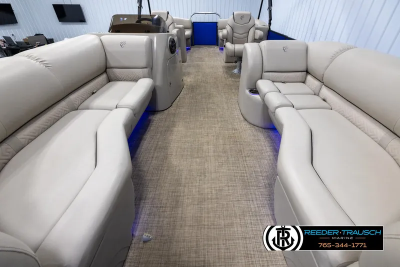 Slide: The Image of 2018 Cypress Cay 233 Seabreeze pontoon boat interior with beige seating and blue accent lighting. - 12