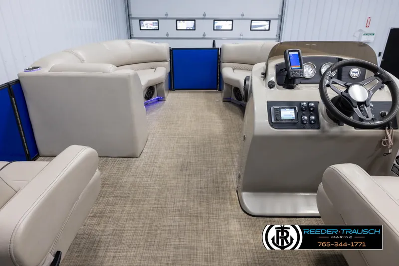 Slide: The Image of 2018 Cypress Cay 233 Seabreeze pontoon boat interior with beige seating and modern dashboard. - 16