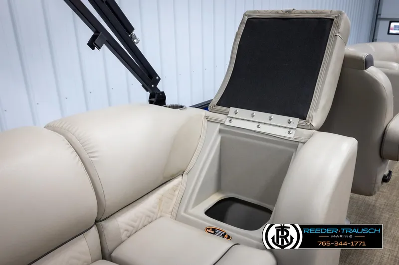 Slide: The Image of 2018 Cypress Cay 233 Seabreeze boat interior with beige seating and storage compartment. - 19