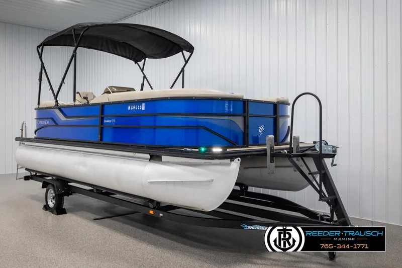 Slide: The Image of 2018 Cypress Cay 233 Seabreeze pontoon boat on trailer in indoor storage. - 2