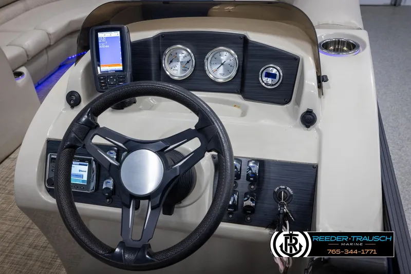 Slide: The Image of 2018 Cypress Cay 233 Seabreeze boat dashboard with steering wheel and gauges. - 20