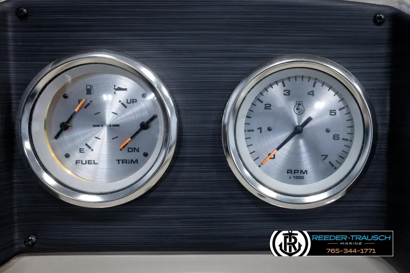 Slide: The Image of Dashboard gauges of a 2018 Cypress Cay 233 Seabreeze boat, showing fuel, trim, and RPM. - 26