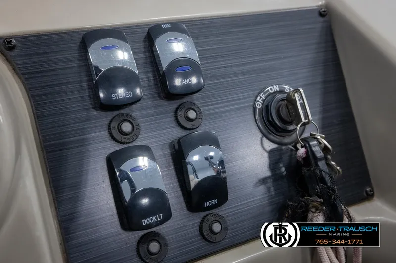 Slide: The Image of Control panel of 2018 Cypress Cay 233 Seabreeze boat with ignition and switches. - 28