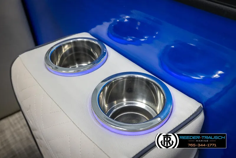 Slide: The Image of Cup holders on 2018 Cypress Cay 233 Seabreeze boat with blue and white interior. - 34