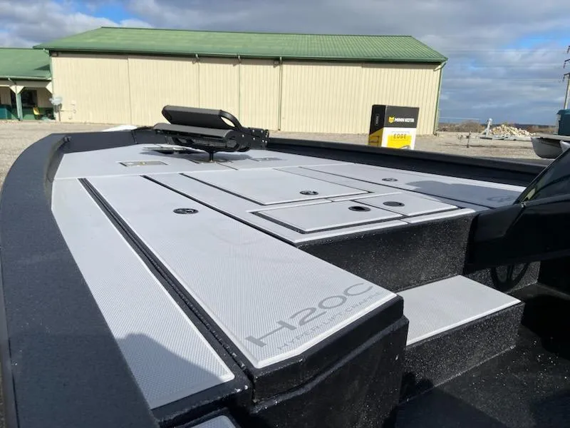 Slide: The Image of 2025 Express H20C boat deck with storage compartments, outdoors near a building. - 6