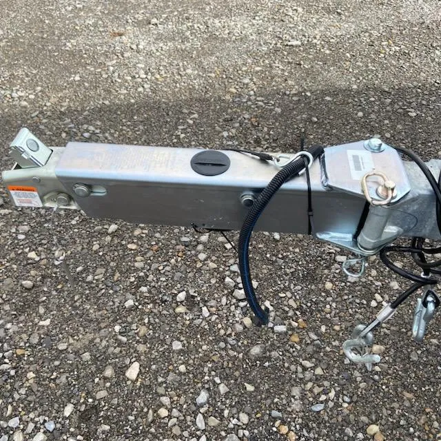 Slide: The Image of Trailer hitch of 2025 Express H20C on gravel surface. - 9