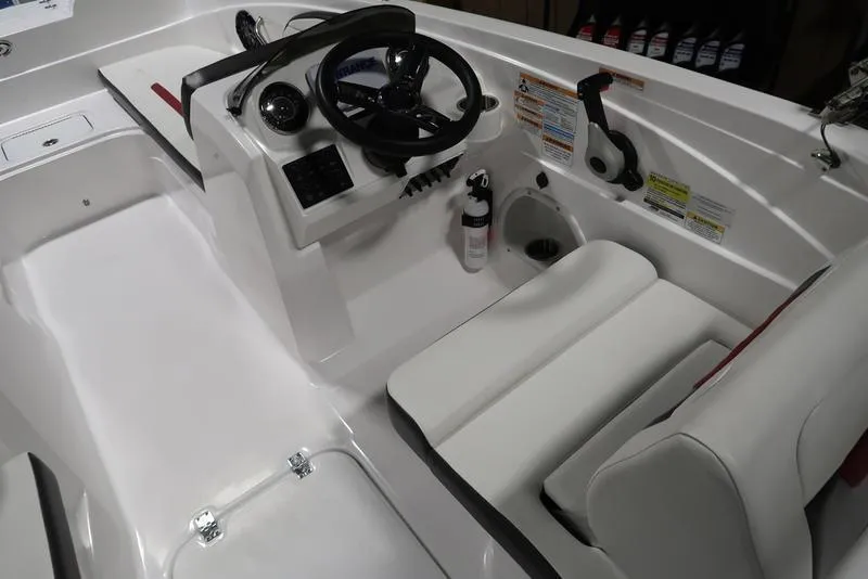Slide: The Image of 2023 Hurricane SunDeck Sport 205 OB boat interior with steering wheel and seating area. - 11