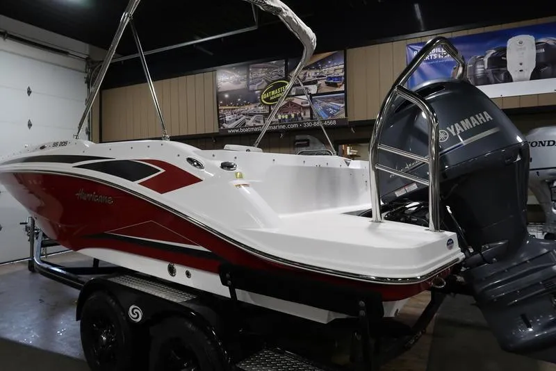 Slide: The Image of 2023 Hurricane SunDeck Sport 205 OB boat with Yamaha outboard motor in showroom. - 3