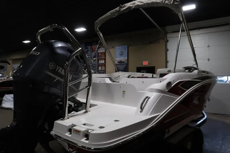 Slide: The Image of 2023 Hurricane SunDeck Sport 205 OB boat with Yamaha engine in indoor showroom. - 5