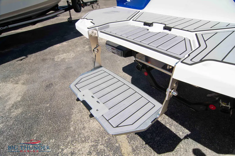 Slide: The Image of 2024 MasterCraft XT24 swim platform with foldable step on a boat trailer. - 10