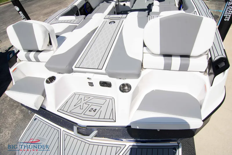 Slide: The Image of 2024 MasterCraft XT24 boat interior with gray and white seating, featuring modern design elements. - 12